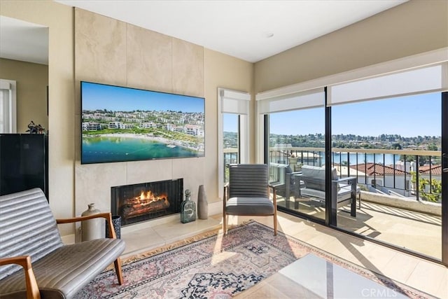 living area featuring tile patterned floors and a tiled fireplace