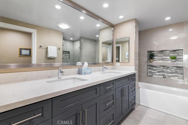 full bath with tile patterned floors, a garden tub, a sink, and double vanity