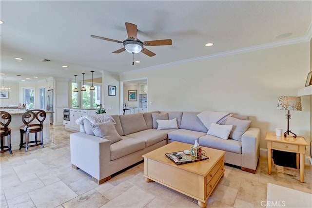 living room featuring ornamental molding, ceiling fan with notable chandelier, and recessed lighting