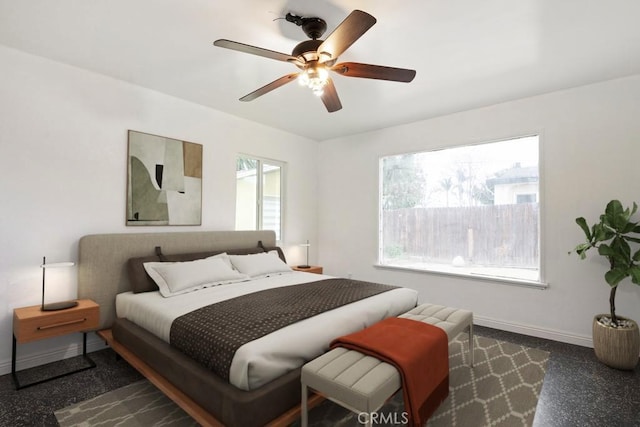 bedroom with a ceiling fan and baseboards