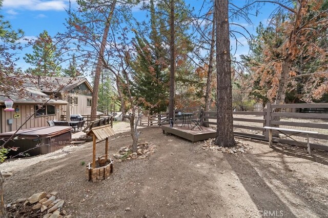 view of yard featuring fence and a deck