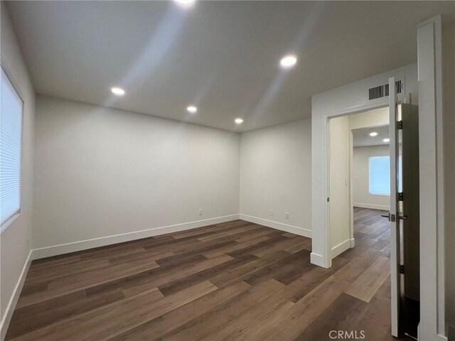 1400 W Warner Ave Unit 60, Santa Ana, CA 92704 - unfurnished room featuring dark wood-style floors, baseboards, visible vents, and recessed lighting