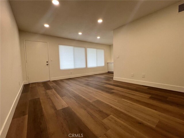 1400 W Warner Ave Unit 60, Santa Ana, CA 92704 - unfurnished room with baseboards, recessed lighting, and dark wood-style floors