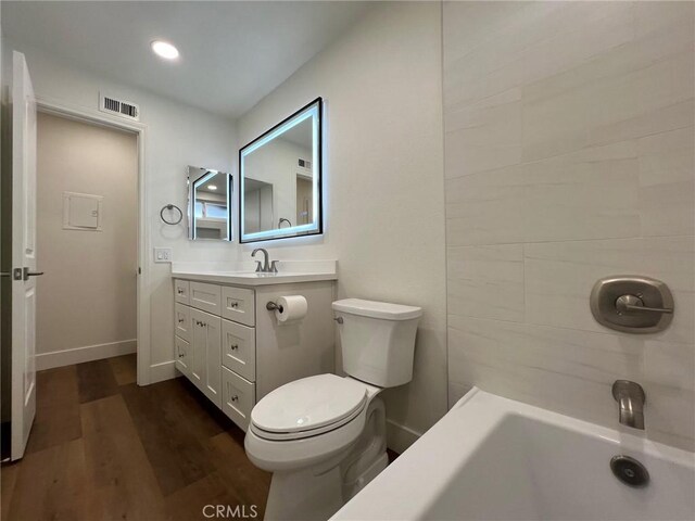 1400 W Warner Ave Unit 60, Santa Ana, CA 92704 - bathroom featuring visible vents, baseboards, toilet, wood finished floors, and vanity