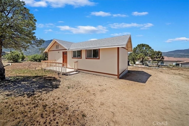 63285 Pinyon Dr, Mountain Center, CA 92561 - ranch-style house with a shingled roof, a mountain view, and stucco siding