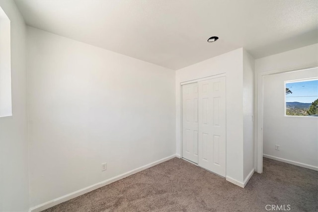 63285 Pinyon Dr, Mountain Center, CA 92561 - unfurnished bedroom with carpet floors, baseboards, and a closet