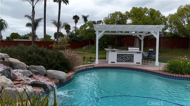 1732 Gamble Ln, Escondido, CA 92029 - view of swimming pool with a patio area, a fenced backyard, a pergola, and exterior kitchen