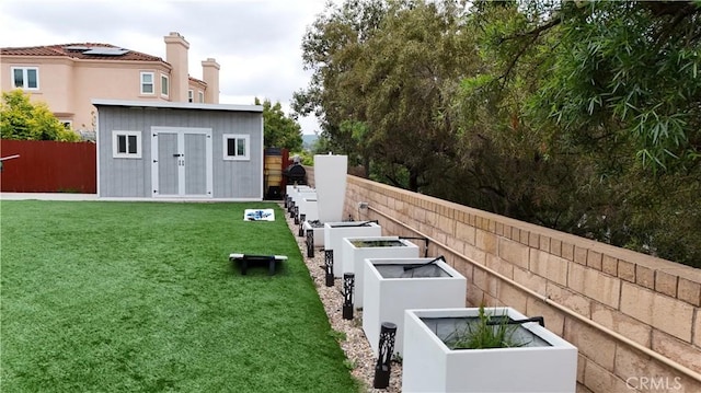 1732 Gamble Ln, Escondido, CA 92029 - fenced backyard featuring a garden and an outdoor structure