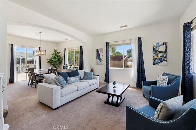 1732 Gamble Ln, Escondido, CA 92029 - living room with arched walkways, carpet, and healthy amount of natural light
