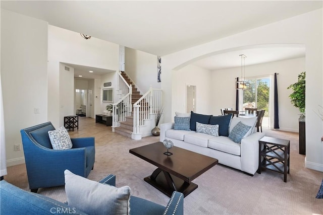 1732 Gamble Ln, Escondido, CA 92029 - living area with arched walkways, stairway, and carpet