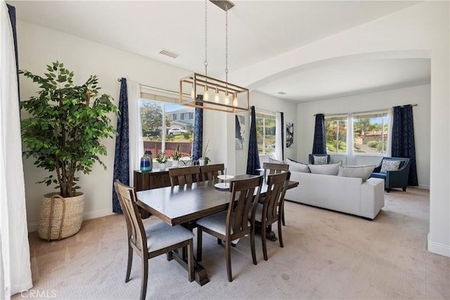 1732 Gamble Ln, Escondido, CA 92029 - dining room featuring light colored carpet, a chandelier, and arched walkways