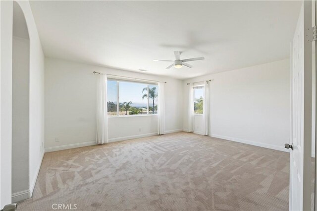 1732 Gamble Ln, Escondido, CA 92029 - empty room featuring a ceiling fan, carpet flooring, and arched walkways