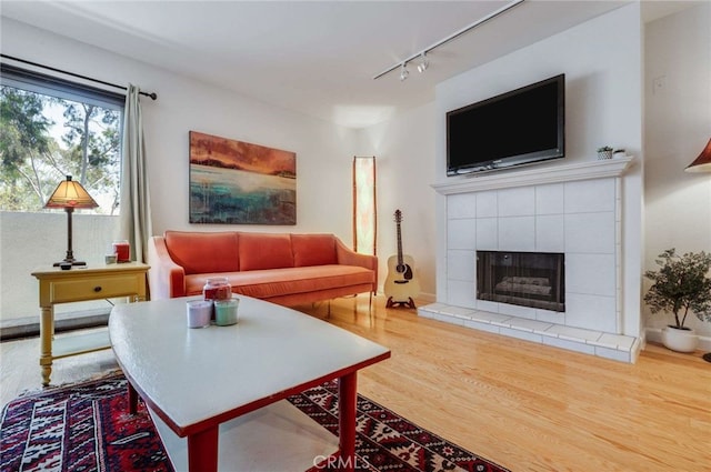 1940 N Highland Ave Unit 69, Los Angeles, CA 90068 - living room featuring track lighting, wood finished floors, and a fireplace