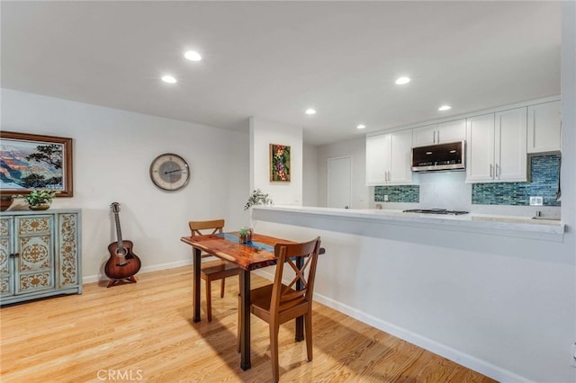 dining area featuring baseboards, recessed lighting, and light wood-style flooring