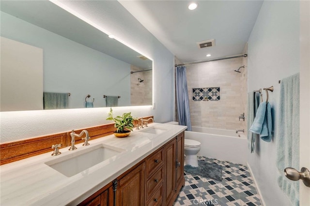 bathroom featuring a sink, shower / tub combo with curtain, toilet, and visible vents