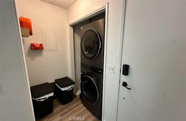 1920 S Mcclelland St Unit 27A, Santa Maria, CA 93454 - washroom featuring estacked washer and dryer, light wood-style flooring, a textured ceiling, and electric panel