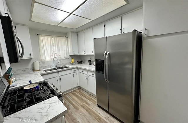 1920 S Mcclelland St Unit 27A, Santa Maria, CA 93454 - kitchen with stainless steel appliances, a sink, light wood finished floors, and white cabinets