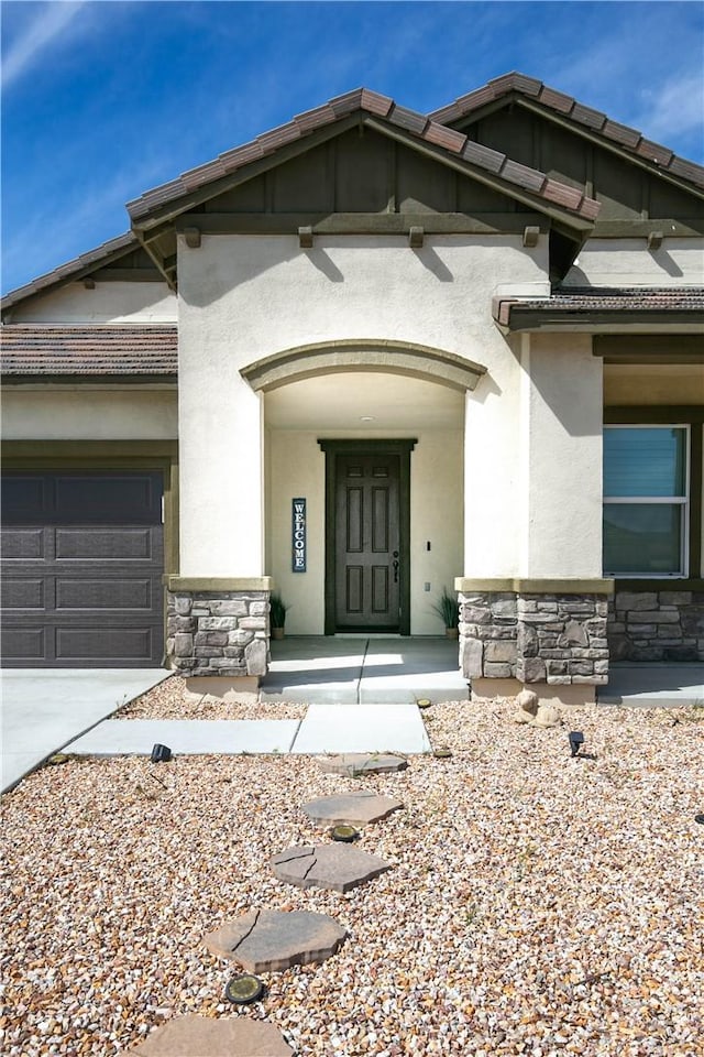 6335 Oldfield St, Lancaster, CA 93536 - view of front of house featuring stone siding, driveway, an attached garage, and stucco siding