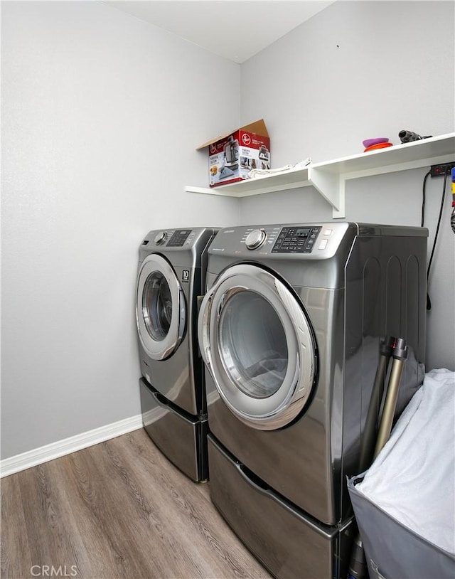 6335 Oldfield St, Lancaster, CA 93536 - laundry room featuring wood finished floors and separate washer and dryer