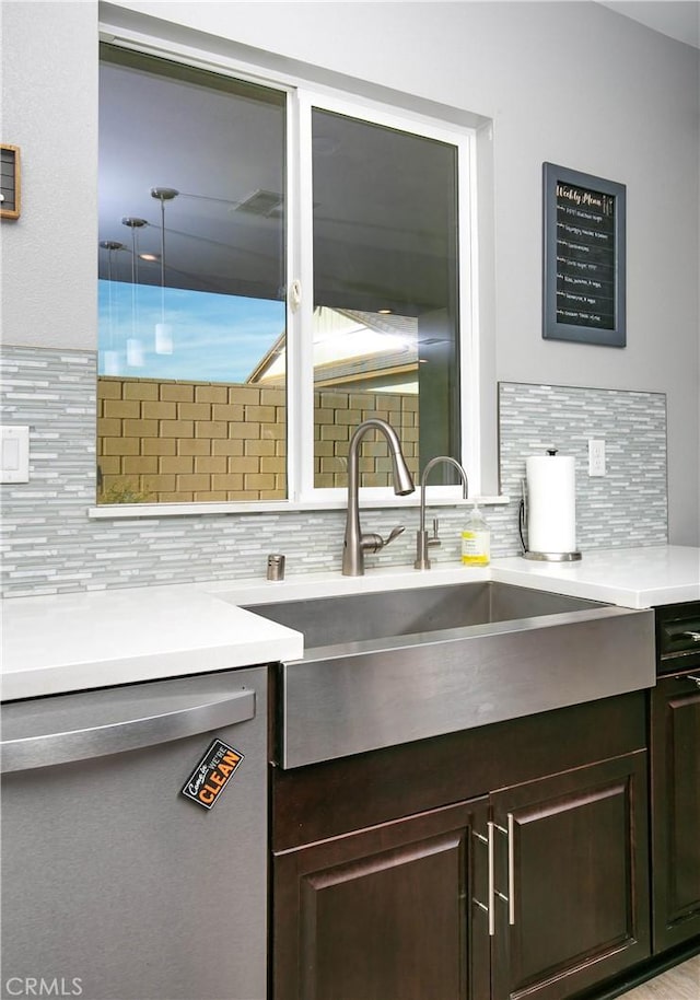 6335 Oldfield St, Lancaster, CA 93536 - kitchen featuring stainless steel dishwasher, tasteful backsplash, dark brown cabinets, and light countertops