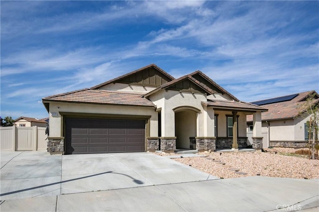 6335 Oldfield St, Lancaster, CA 93536 - view of front of home featuring stone siding, driveway, a garage, stucco siding, and a tiled roof