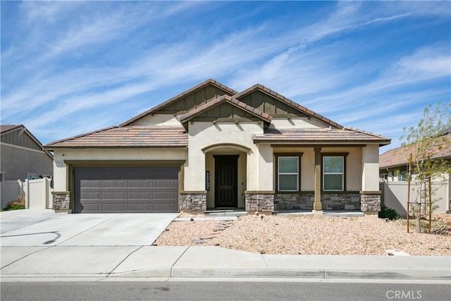 6335 Oldfield St, Lancaster, CA 93536 - craftsman house featuring stone siding, a garage, driveway, and stucco siding