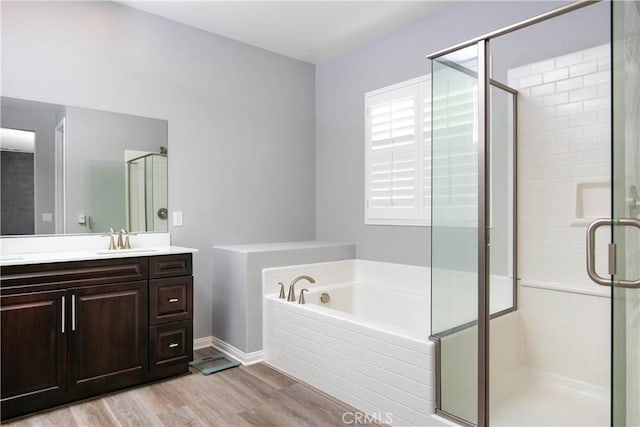 6335 Oldfield St, Lancaster, CA 93536 - full bathroom with vanity, wood finished floors, a stall shower, and a bath