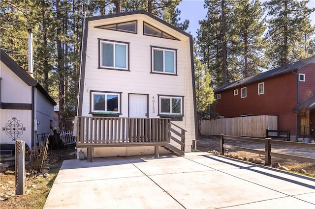 view of front of home with fence and a patio area