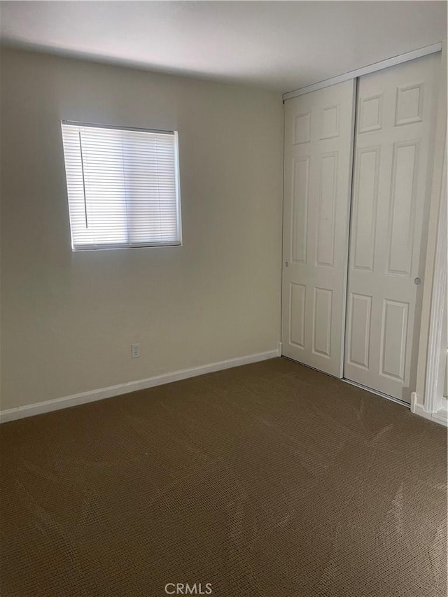 8772 Mignonette St, Rancho Cucamonga, CA 91701 - unfurnished bedroom with dark colored carpet, a closet, and baseboards