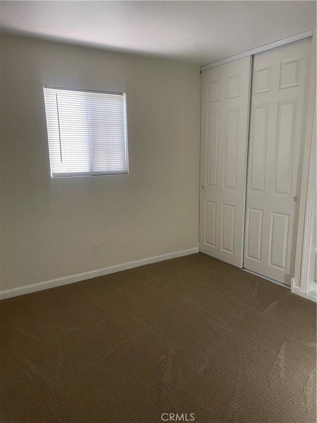 8772 Mignonette St, Rancho Cucamonga, CA 91701 - unfurnished bedroom with dark colored carpet and a closet