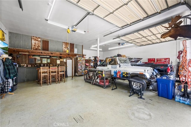 28863 Capano Bay Ct, Menifee, CA 92584 - garage featuring a garage door opener and a workshop area
