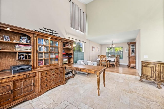 28863 Capano Bay Ct, Menifee, CA 92584 - home office featuring stone tile floors, a high ceiling, and a chandelier