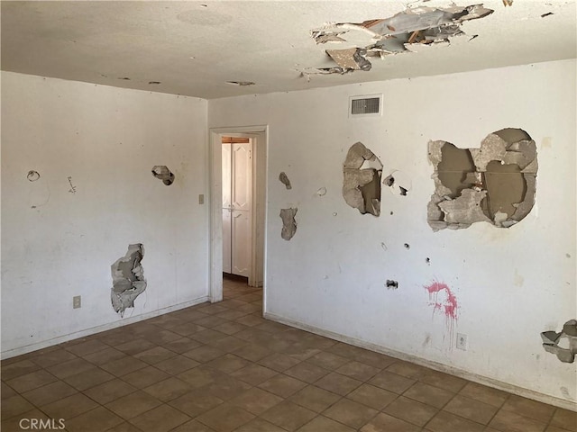 unfurnished room with visible vents
