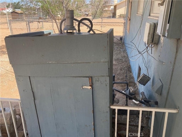 view of storm shelter with fence