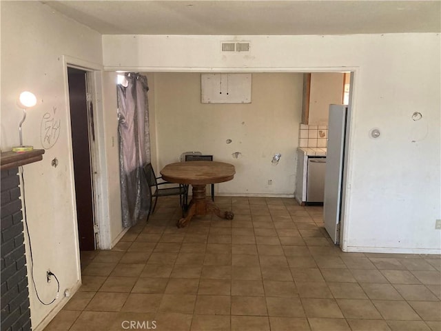 dining space featuring visible vents and light tile patterned floors