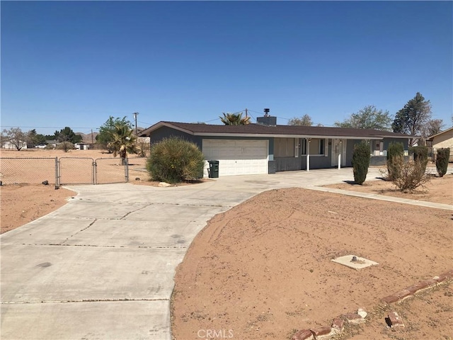 single story home featuring a gate, driveway, fence, and a garage