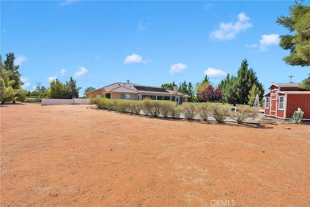 view of yard featuring an outdoor structure and a storage shed