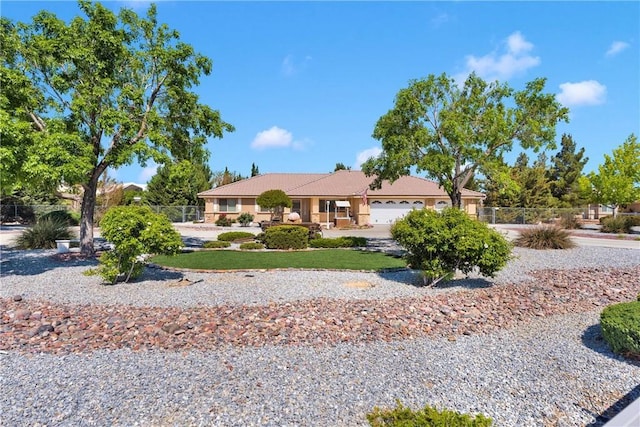 ranch-style house with fence and an attached garage
