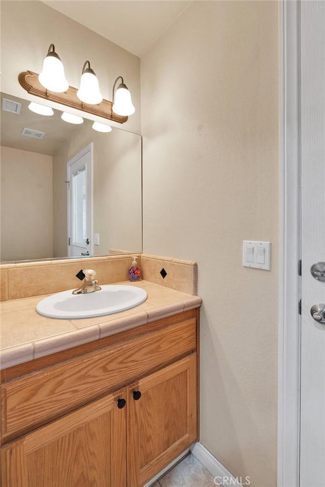 bathroom featuring visible vents and vanity
