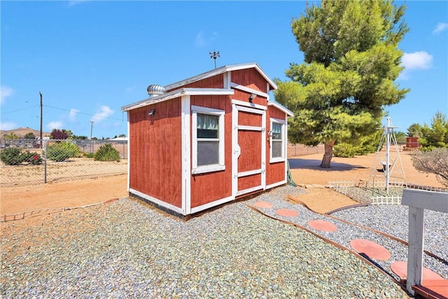 view of shed featuring fence