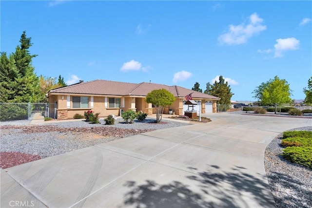 ranch-style home with a gate, fence, concrete driveway, stucco siding, and a tile roof