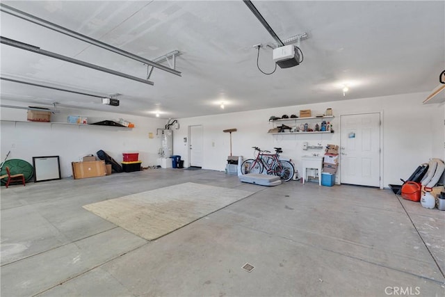 garage featuring water heater and a garage door opener