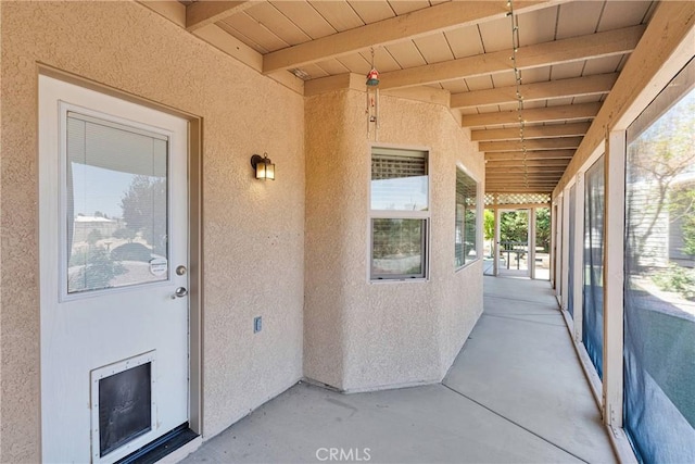 doorway to property featuring stucco siding