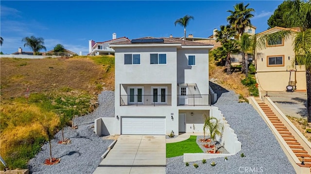 29847 Smugglers Point Dr, Canyon Lake, CA 92587 - view of front facade with french doors, a balcony, solar panels, stucco siding, and driveway