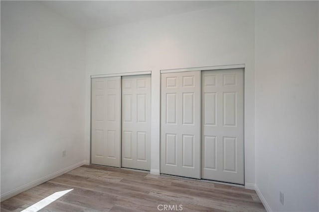 29847 Smugglers Point Dr, Canyon Lake, CA 92587 - unfurnished bedroom featuring wood finished floors and two closets