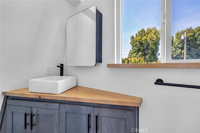 bathroom featuring a healthy amount of sunlight and vanity
