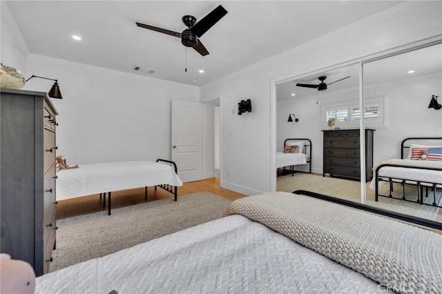 bedroom featuring ceiling fan, crown molding, wood finished floors, and recessed lighting