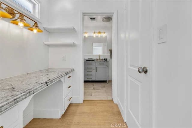 bathroom with vanity, wood finished floors, and visible vents