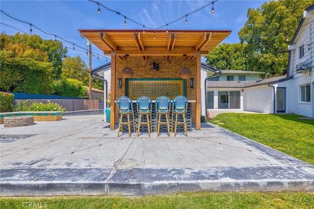 view of patio / terrace with outdoor dry bar and fence