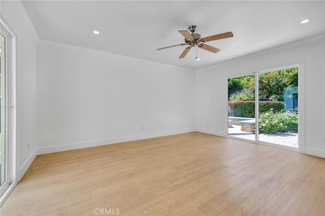 empty room with light wood-type flooring, a ceiling fan, and crown molding